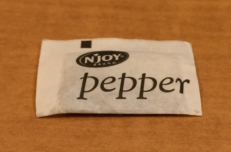 A photo of single packet of pepper.